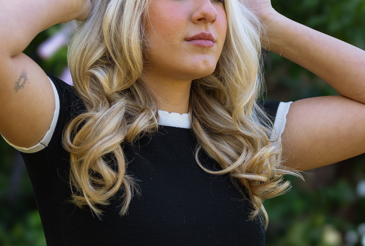 girl releasing her hair after taking out the heatless curling rod to get effortless heatless curls.